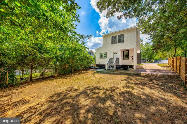 a view of a yard with wooden fence