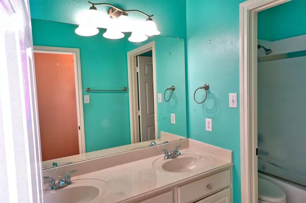 a bathroom with a sink vanity and a mirror