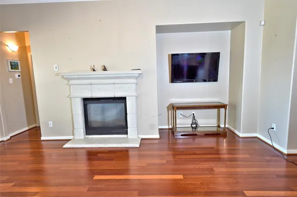 a living room with a fireplace and a wooden floor