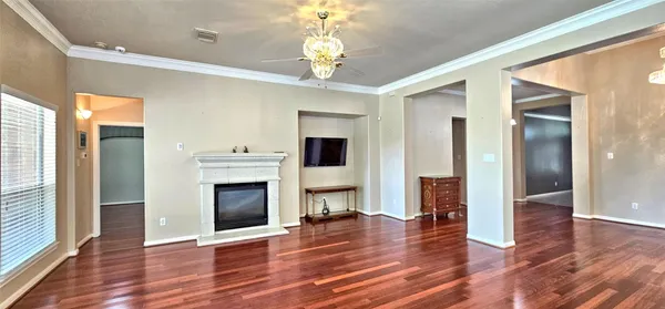 a view of a livingroom with wooden floor a fireplace and window