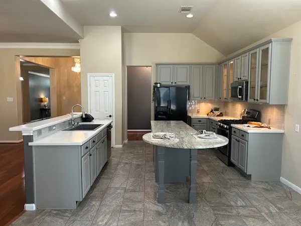 a kitchen with a sink stove and refrigerator