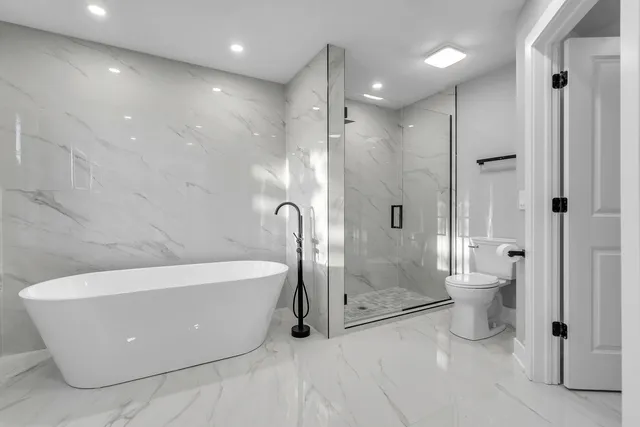 a bathroom with a tub and shower