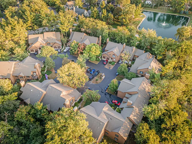 an aerial view of a house with a lake view