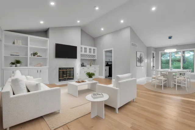 a living room with fireplace furniture and a flat screen tv