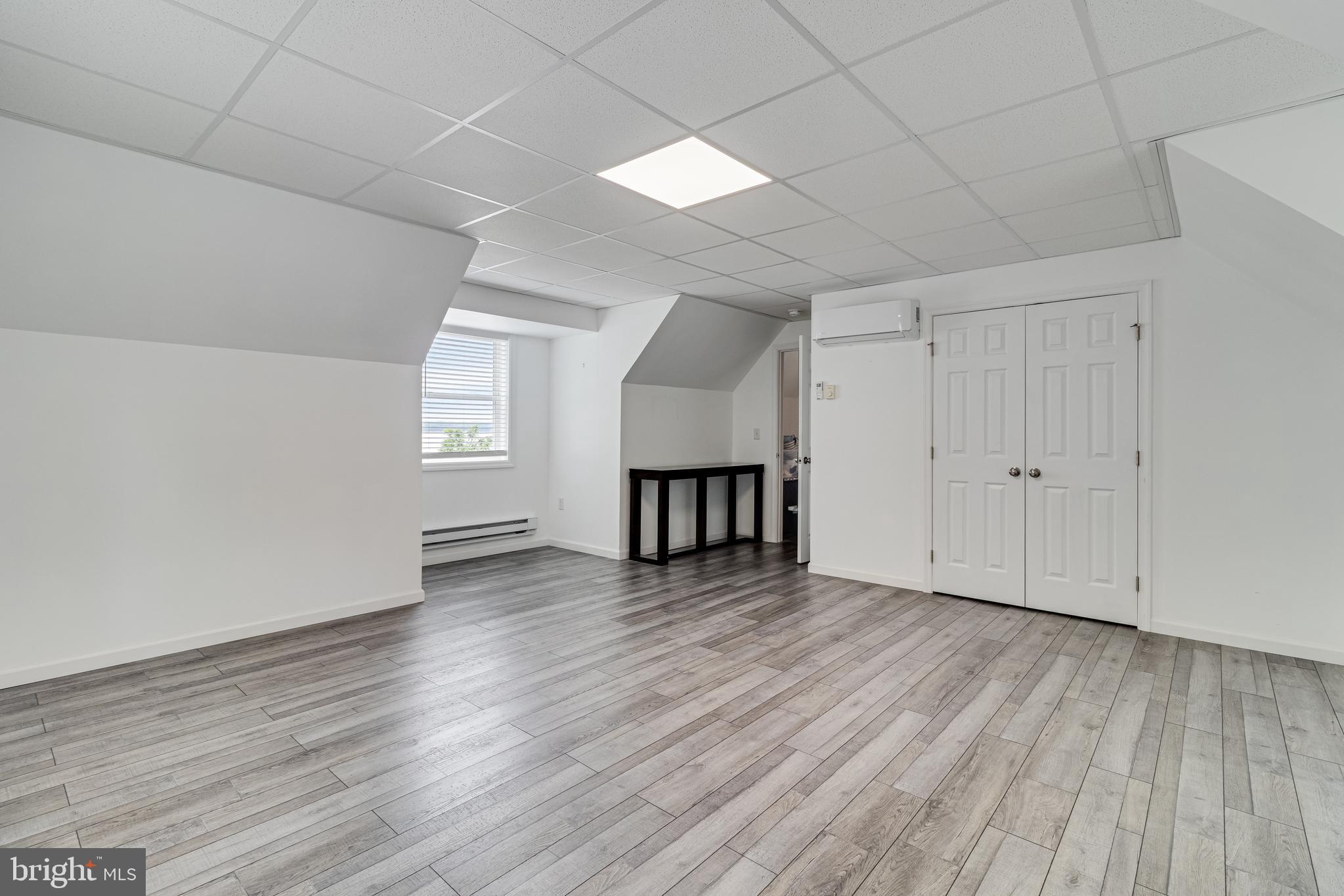 12015 Woodbury Road Nanjemoy, MD 20662 - Photo 5 of 53 a view of an empty room with wooden floor and a window