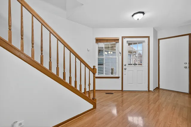 a view of an entryway with wooden floor