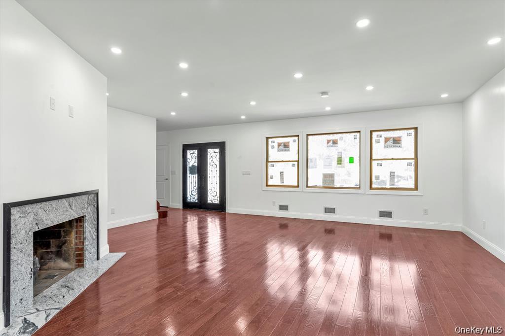 44 School Street Malverne, NY 11565 - Photo 3 of 19 a view of an empty room with wooden floor and a window