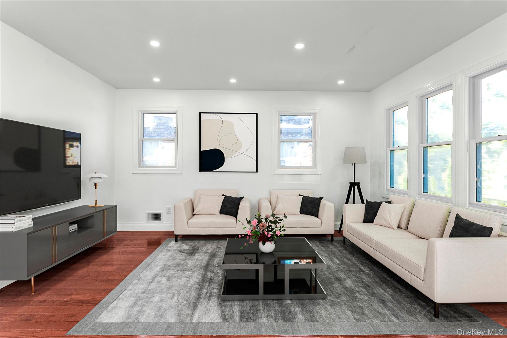 44 School Street Malverne, NY 11565 - Photo 5 of 19 a living room with furniture and a flat screen tv