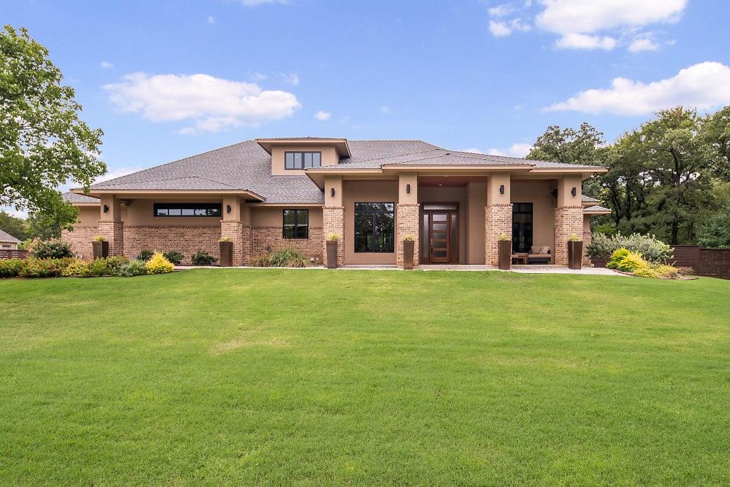 a front view of house with yard and green space