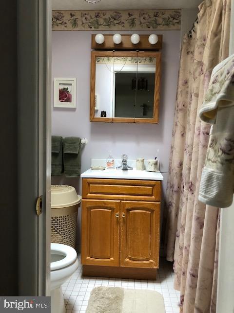 237 Lauriston Street Philadelphia, PA 19128 - Photo 14 of 22 a bathroom with a toilet a sink and a mirror