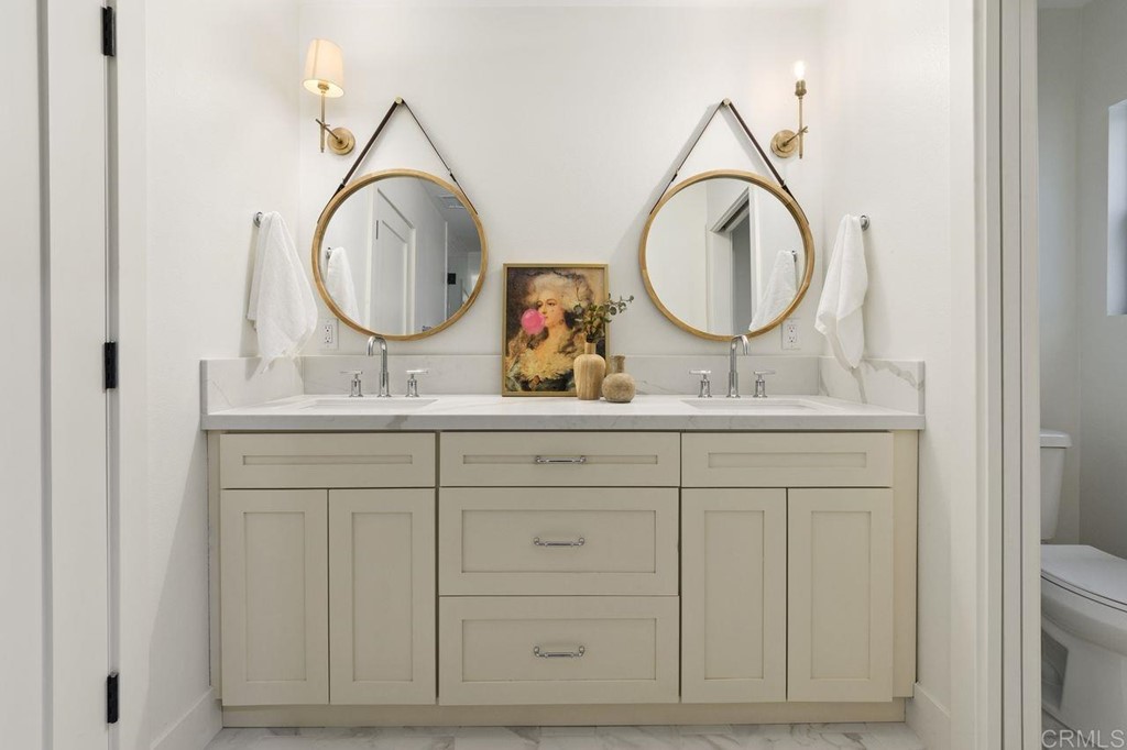 13705 Mango Drive Del Mar, CA 92014 - Photo 23 of 35 a bathroom with a double vanity sink and a mirror