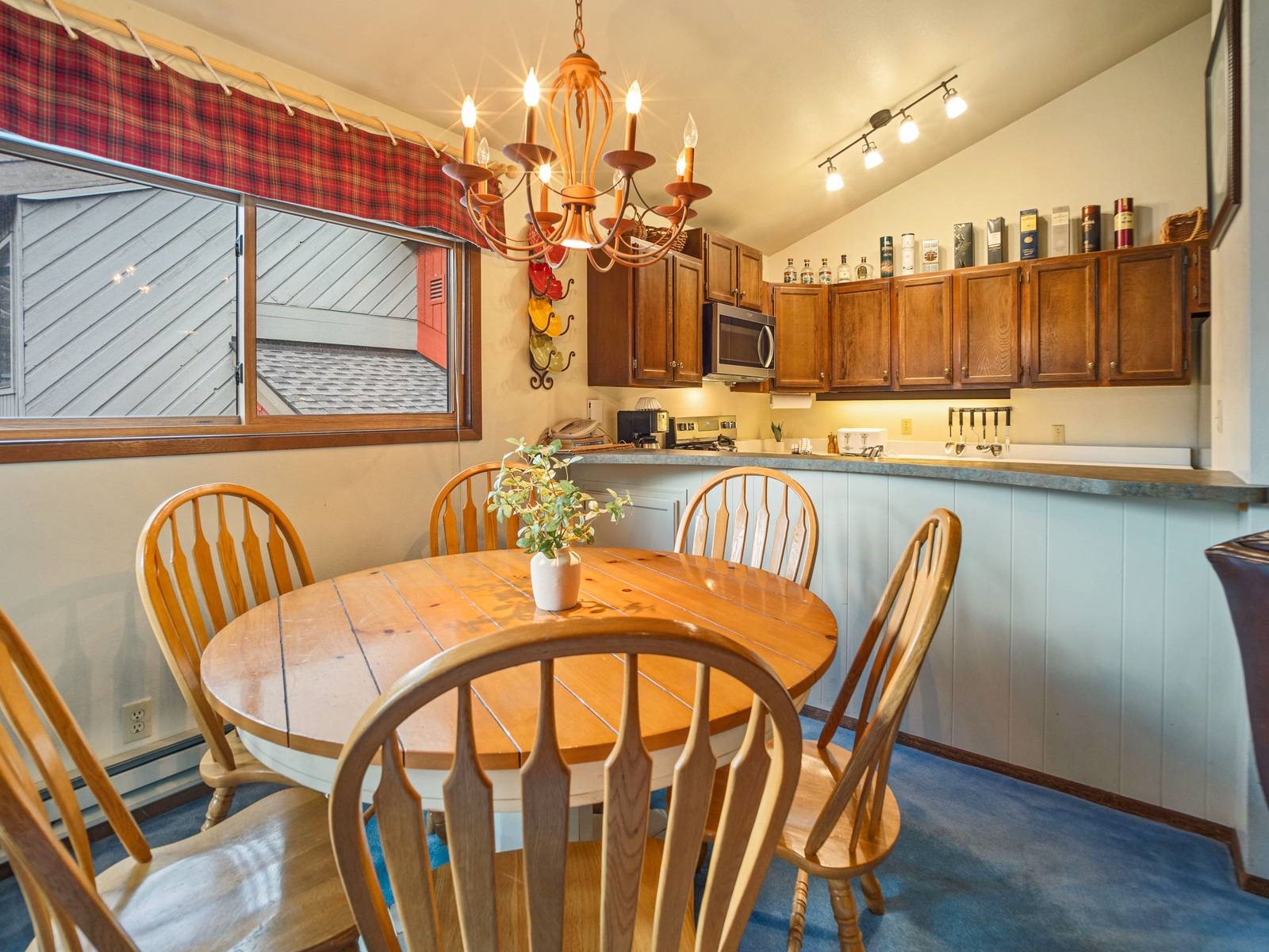 1937 Soda Ridge Road, Unit 1139 Keystone, CO 80435 - Photo 14 of 32 Carpeted dining space with lofted ceiling and a notable chandelier