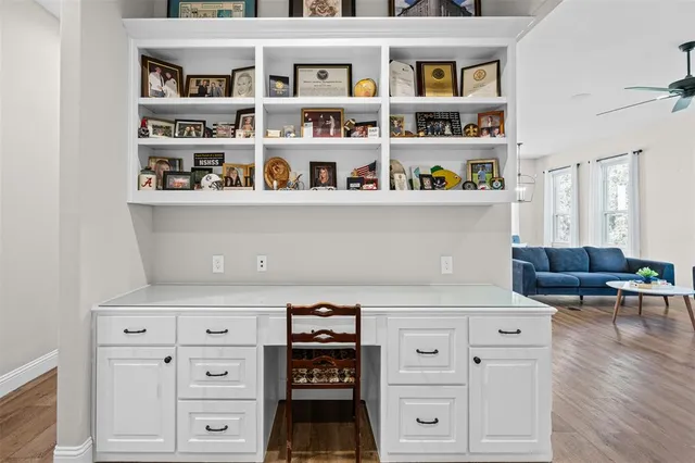 a view of room with window ceiling fan and hardwood floor