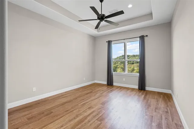 a spacious bathroom with a granite countertop sink mirror and bathtub