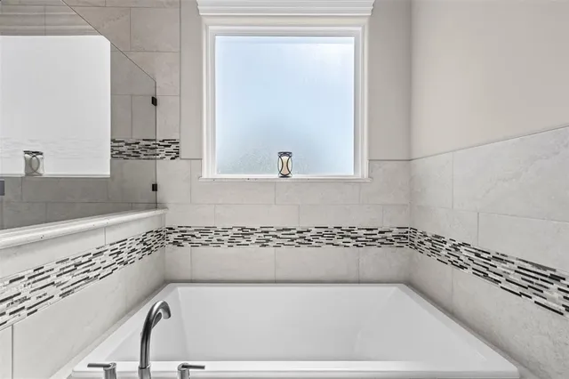 a en suite bathroom with a double vanity sink and a mirror