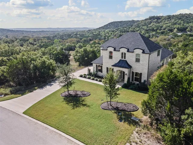 a aerial view of a house with swimming pool garden and patio