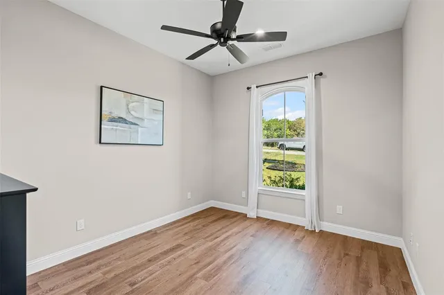 a bathroom with a granite countertop sink toilet mirror and shower
