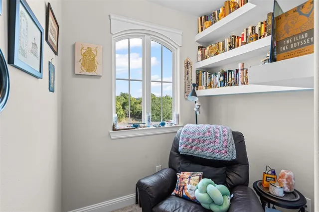 a hallway with couches and a window