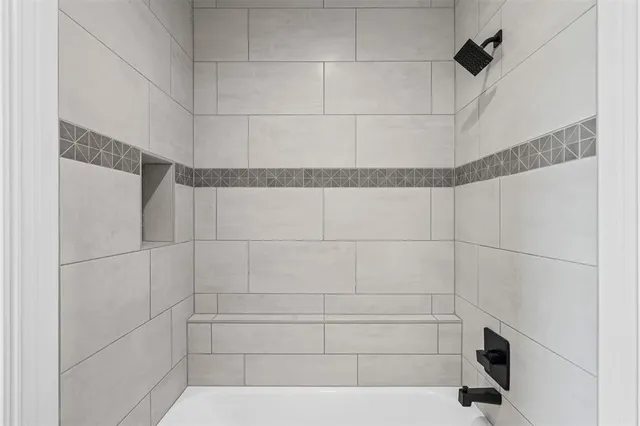 a bathroom with a bathtub and a shower