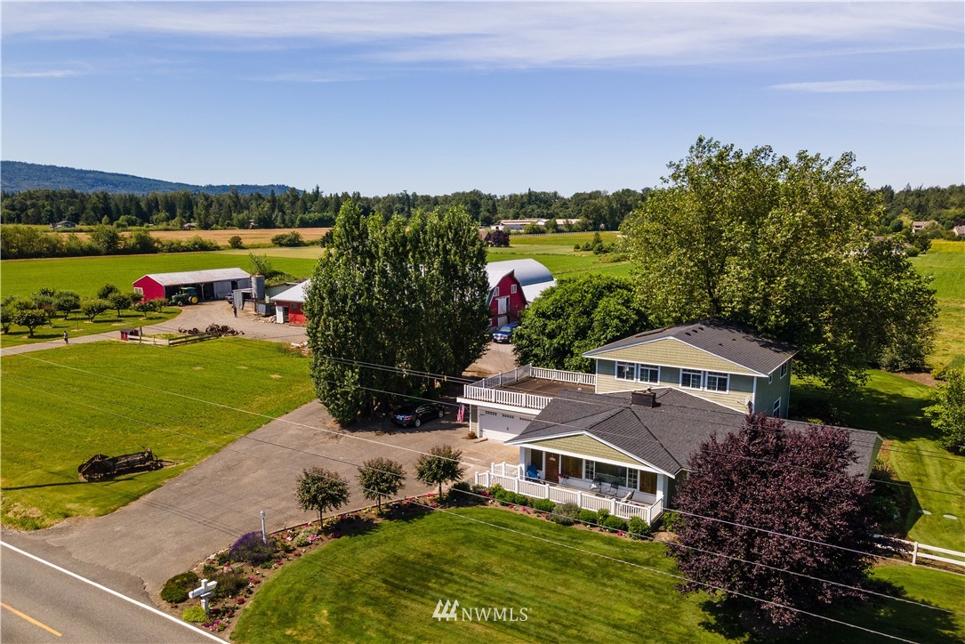 5495 Sand Road Bellingham, WA 98226 - Photo 1 of 40 an aerial view of a house with a garden and lake view