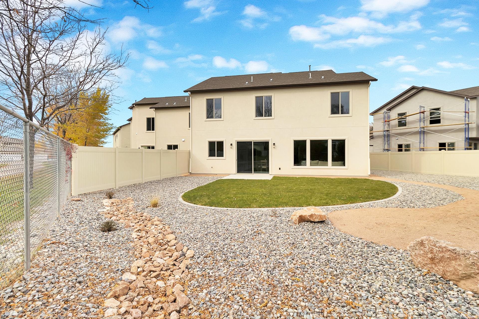1124 Sprocket Court Fruita, CO 81521 - Photo 8 of 40 a view of a white house with a yard