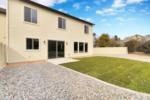 a front view of a house with a garden and yard