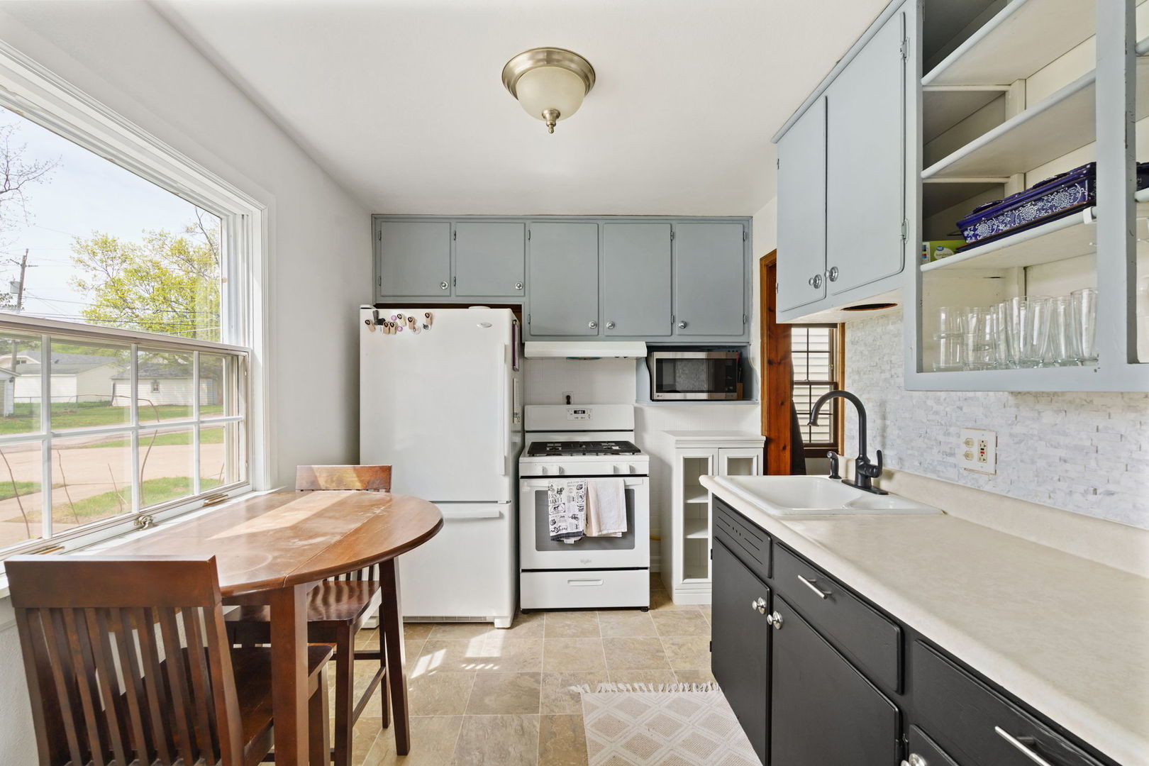 2330 39th Street Rock Island, IL 61201 - Photo 8 of 32 a kitchen with stainless steel appliances granite countertop a stove a sink dishwasher and a refrigerator