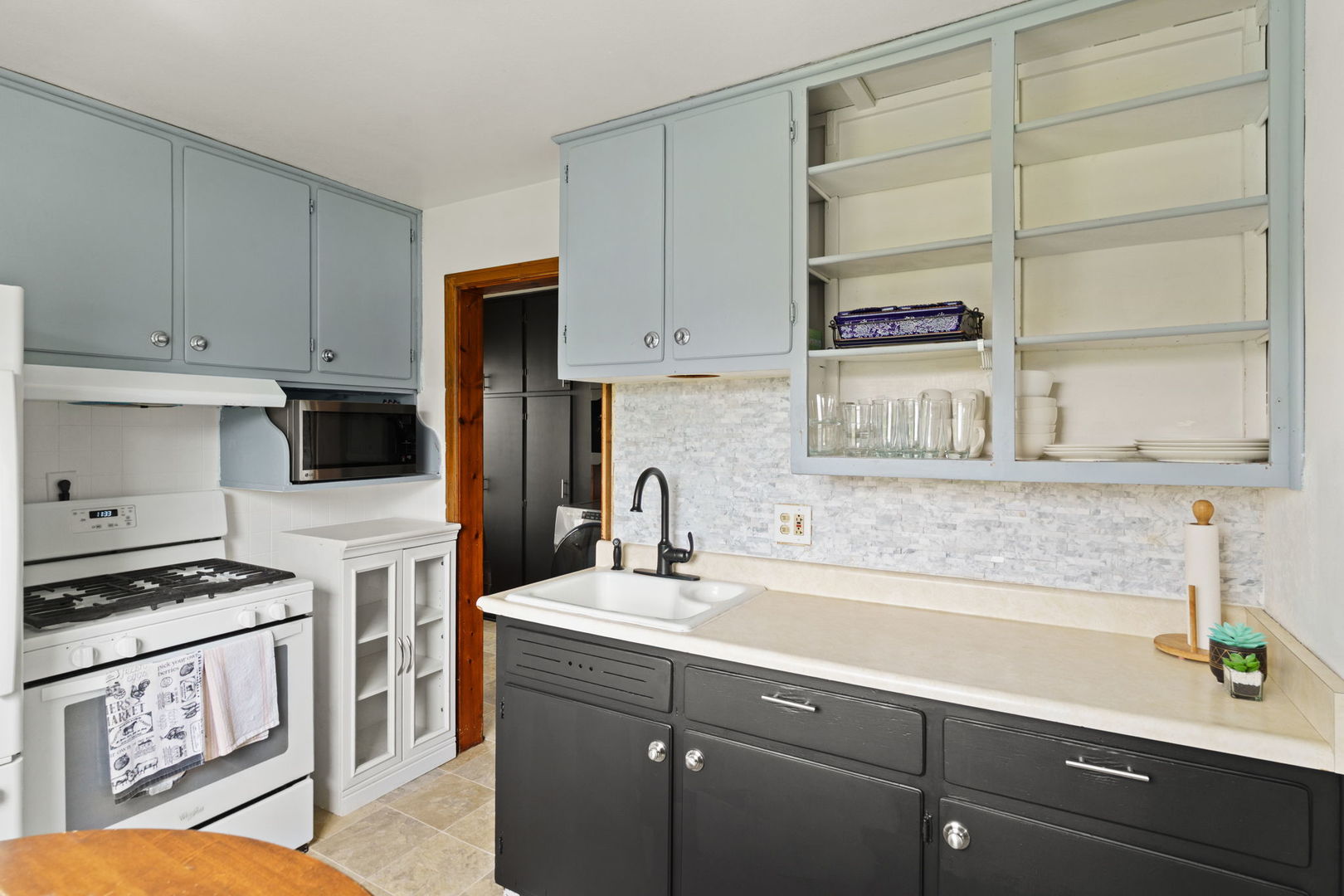 2330 39th Street Rock Island, IL 61201 - Photo 10 of 32 a kitchen with granite countertop a sink a stove and cabinets