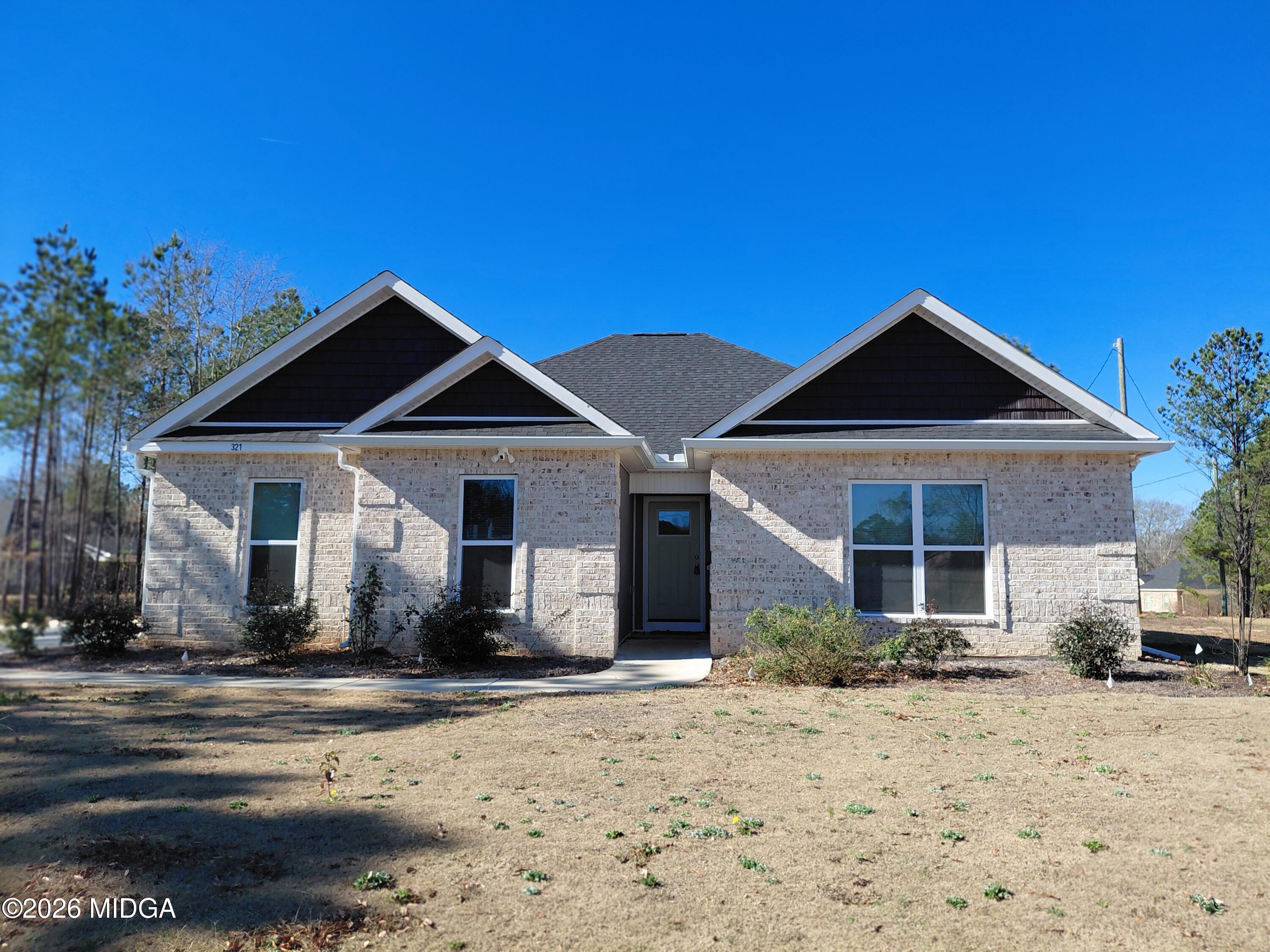 a front view of a house with a yard