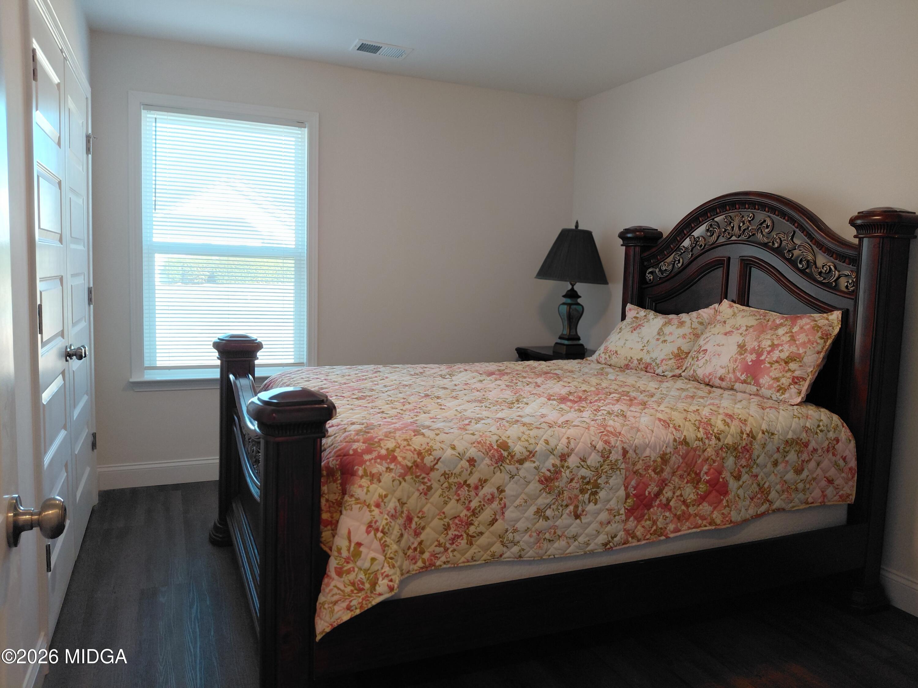 321 Browning Pointe Road Macon, GA 31216 - Photo 11 of 20 a bedroom with a bed and a window