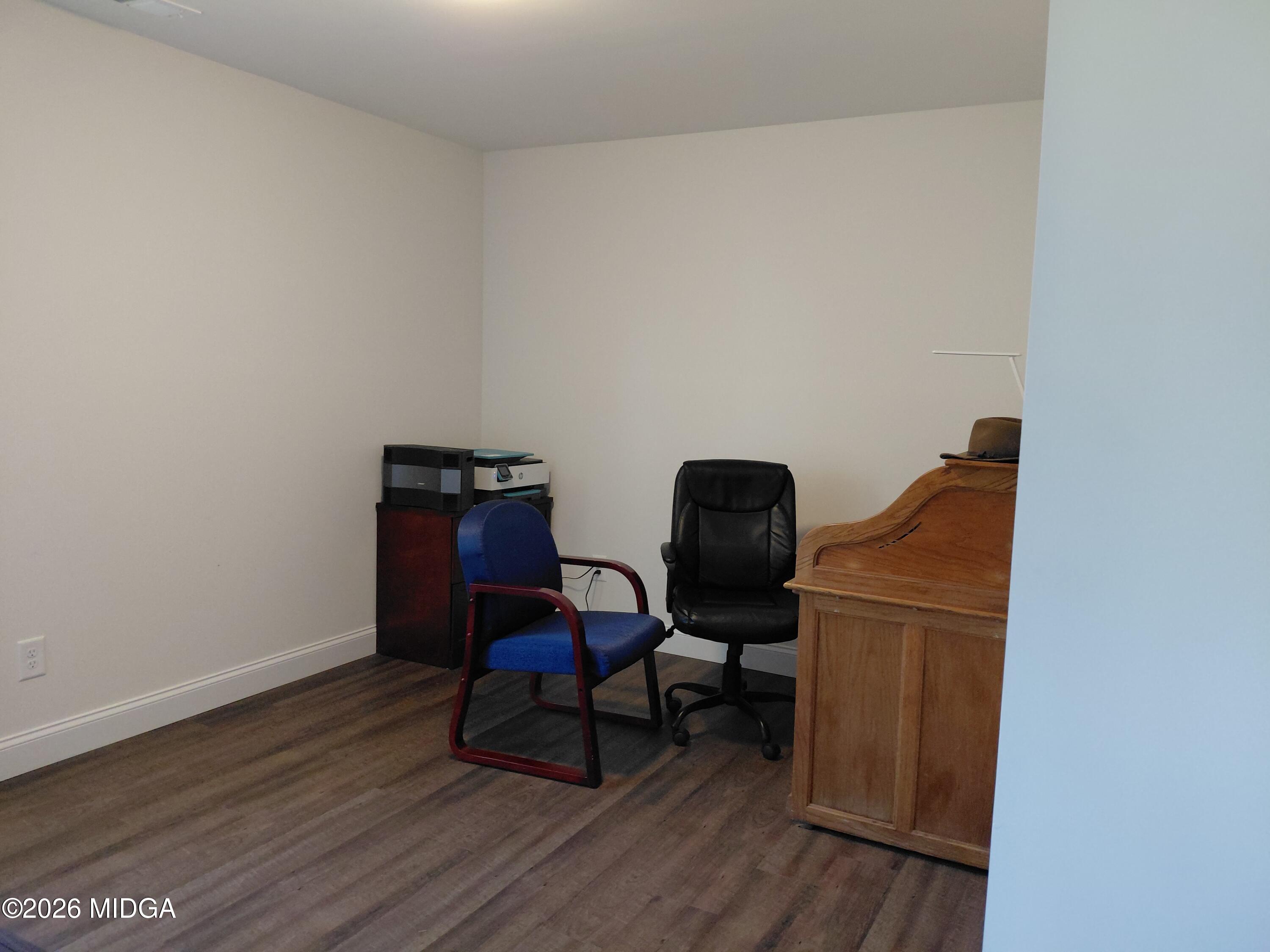 321 Browning Pointe Road Macon, GA 31216 - Photo 13 of 20 a view of workspace with wooden floor lounge chair and windows