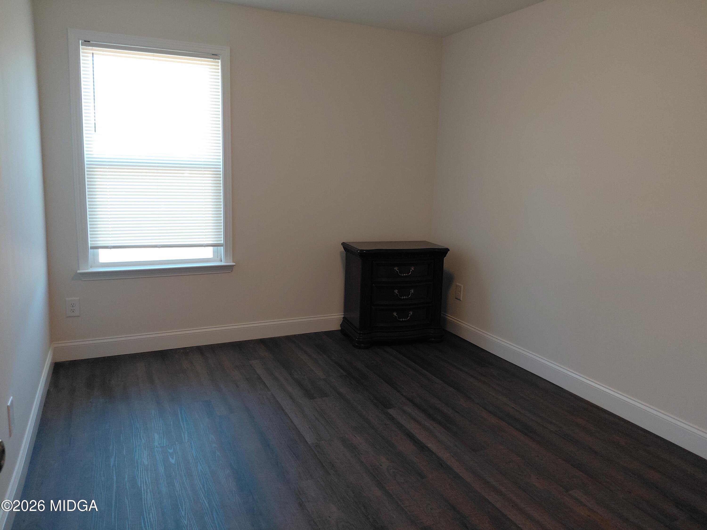 321 Browning Pointe Road Macon, GA 31216 - Photo 14 of 20 an empty room with wooden floor and windows