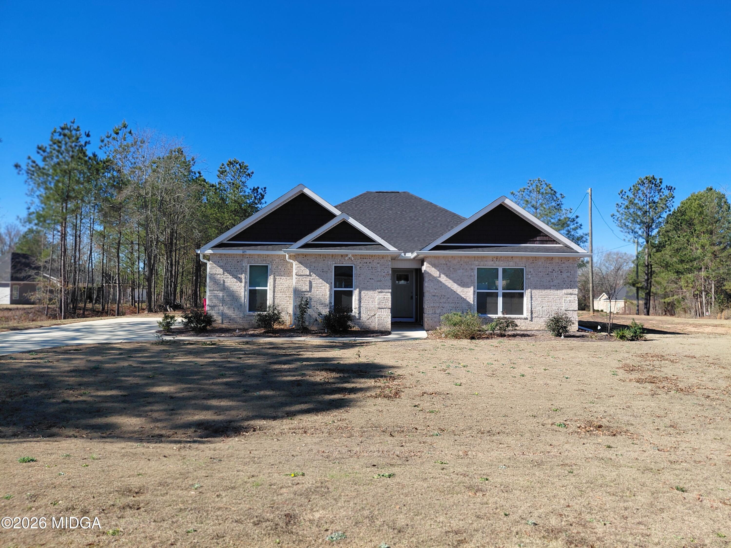 321 Browning Pointe Road Macon, GA 31216 - Photo 20 of 20 a front view of a house with a dirt yard and a large tree