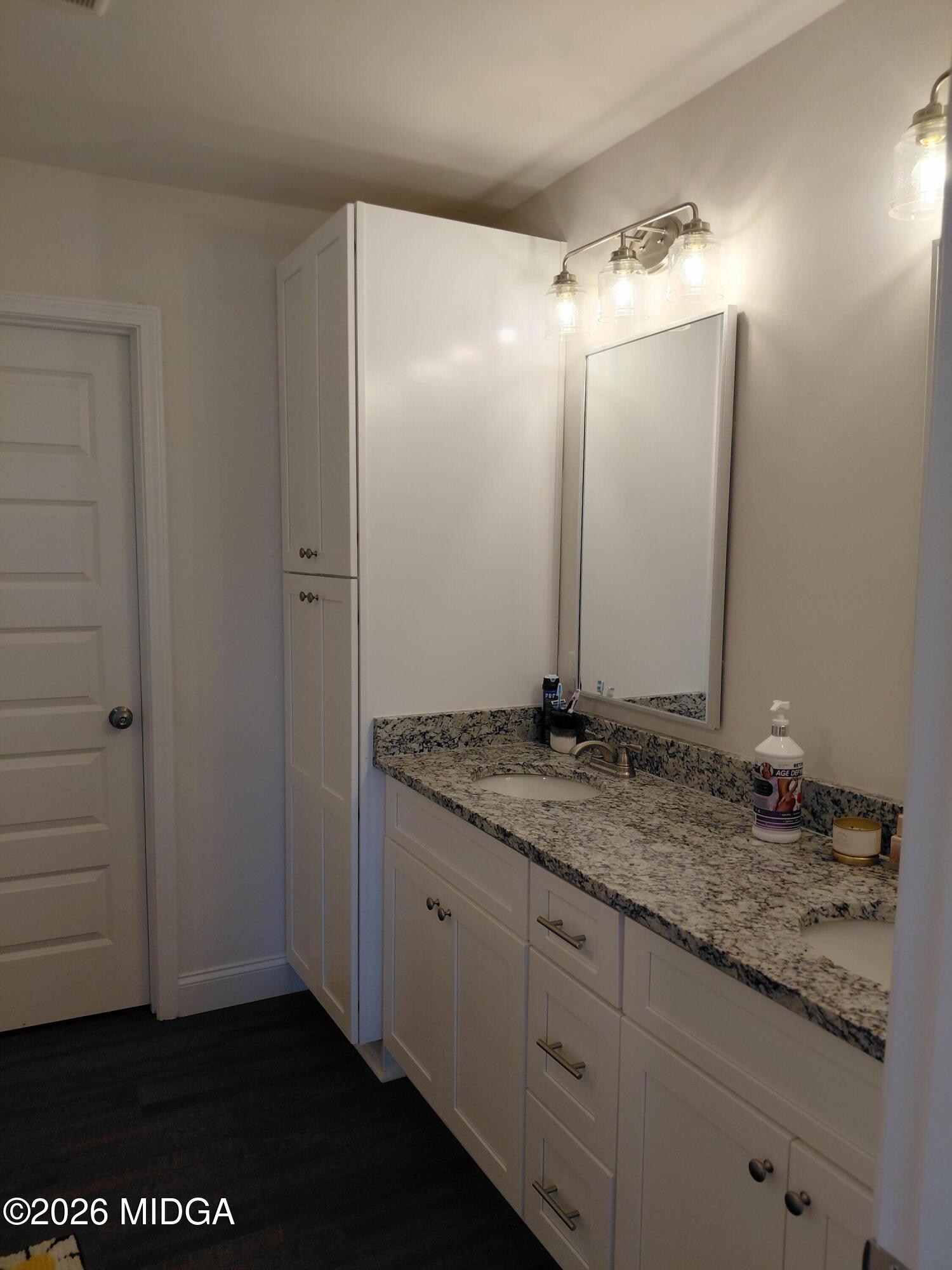 321 Browning Pointe Road Macon, GA 31216 - Photo 5 of 20 a bathroom with a granite countertop sink and a mirror