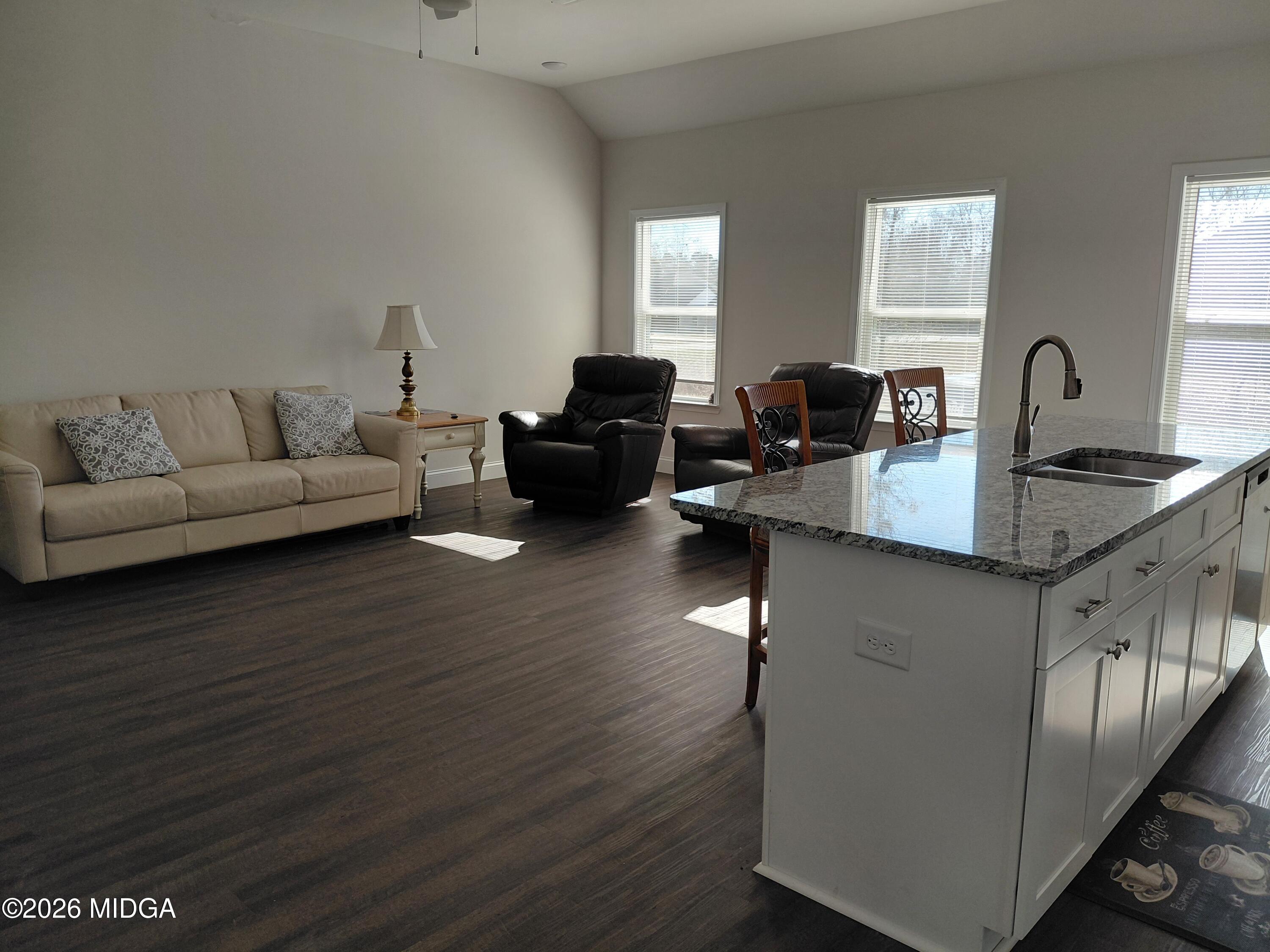 321 Browning Pointe Road Macon, GA 31216 - Photo 7 of 20 a living room with granite countertop couches a fireplace with wooden floor