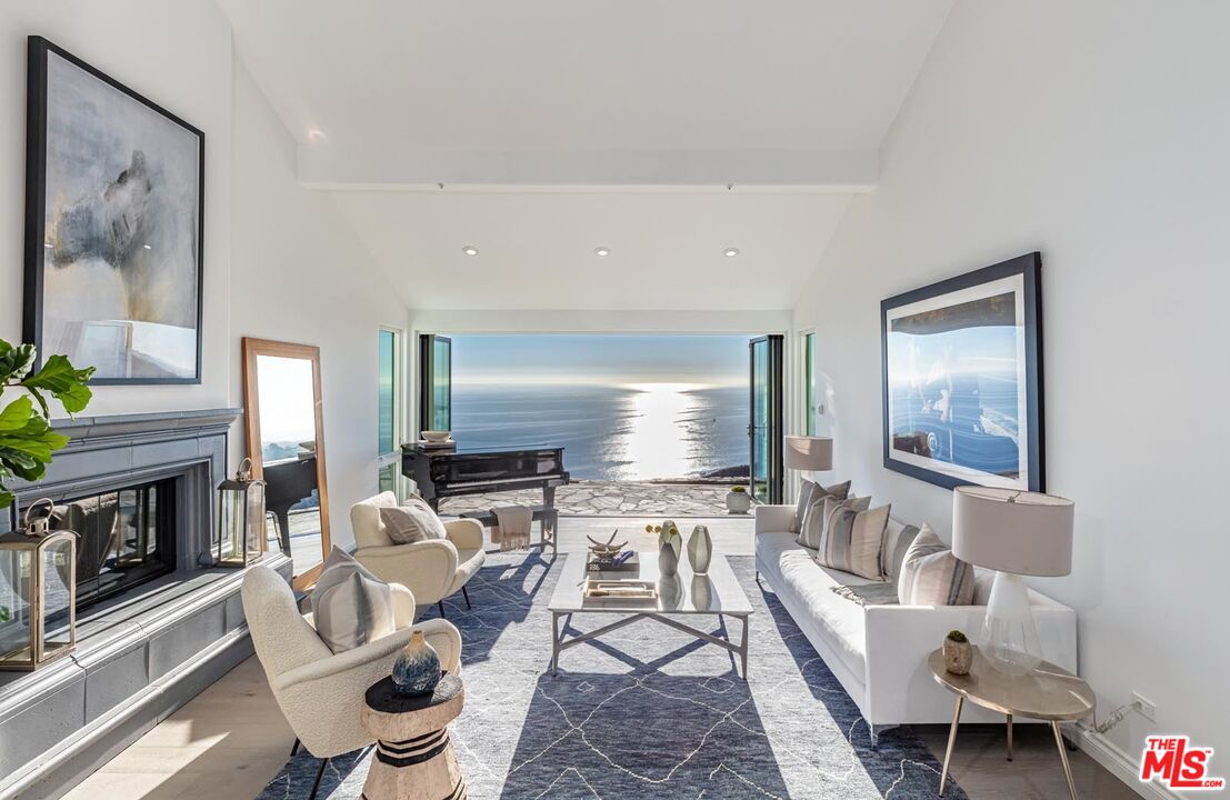 a living room with fireplace furniture and a flat screen tv