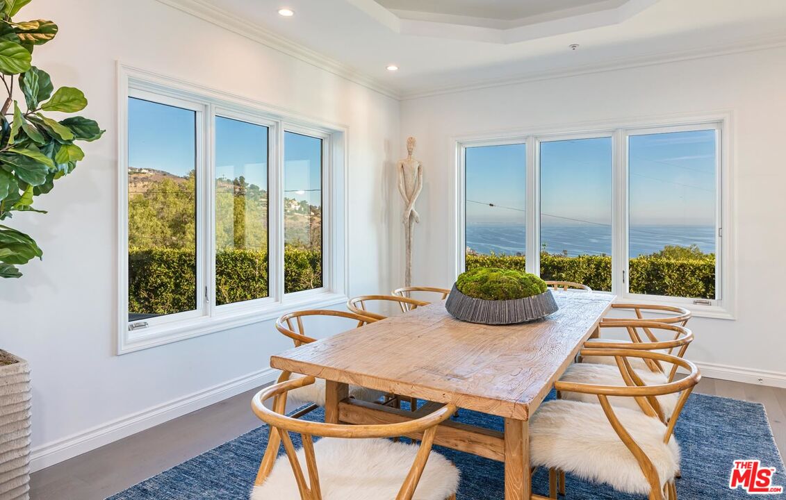 Carbon Mesa Road Malibu, CA 90265 - Photo 12 of 42 a view of a dining room with furniture window and wooden floor