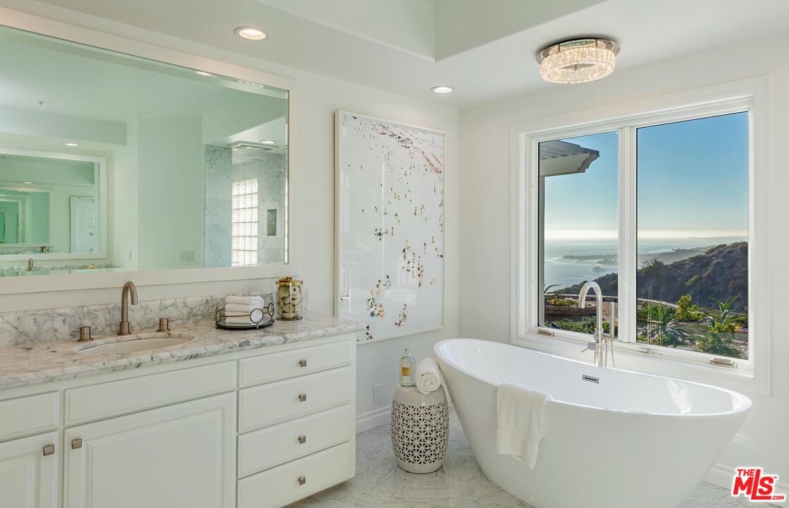 Carbon Mesa Road Malibu, CA 90265 - Photo 16 of 42 a bathroom with a tub sink and mirror