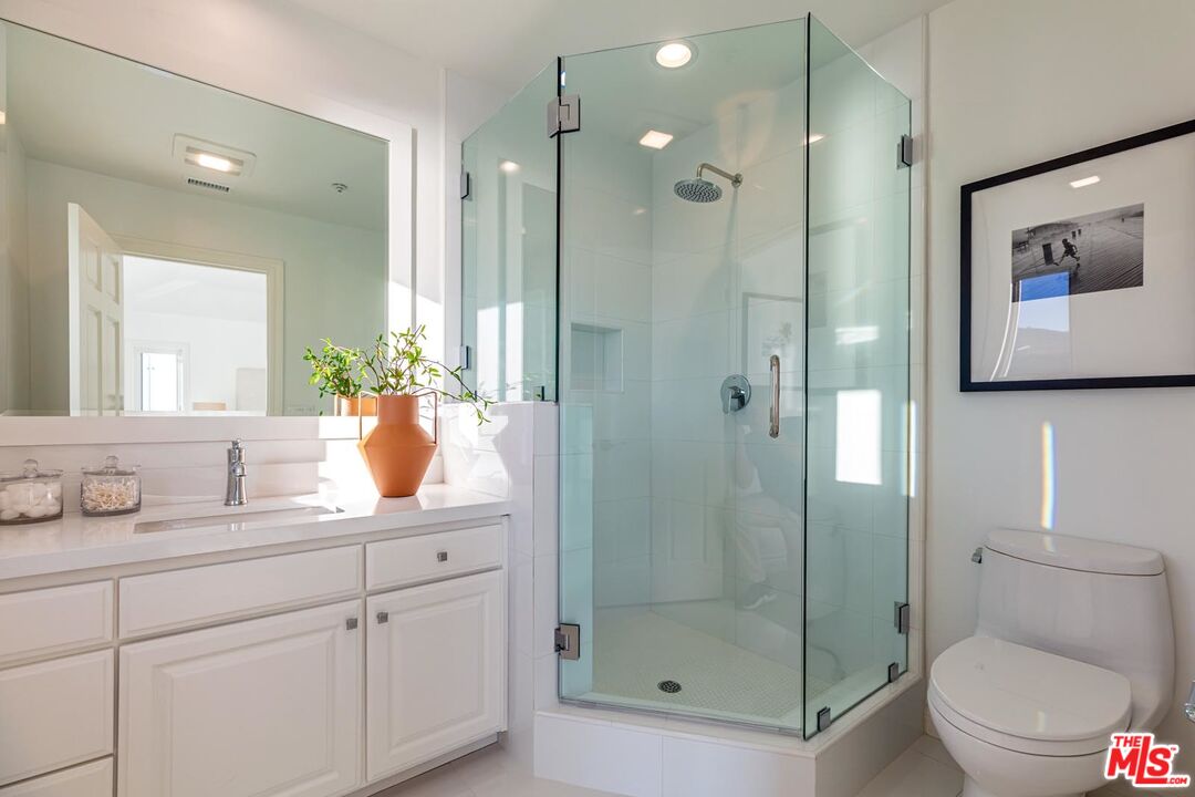 Carbon Mesa Road Malibu, CA 90265 - Photo 21 of 42 a bathroom with a shower sink vanity mirror and toilet