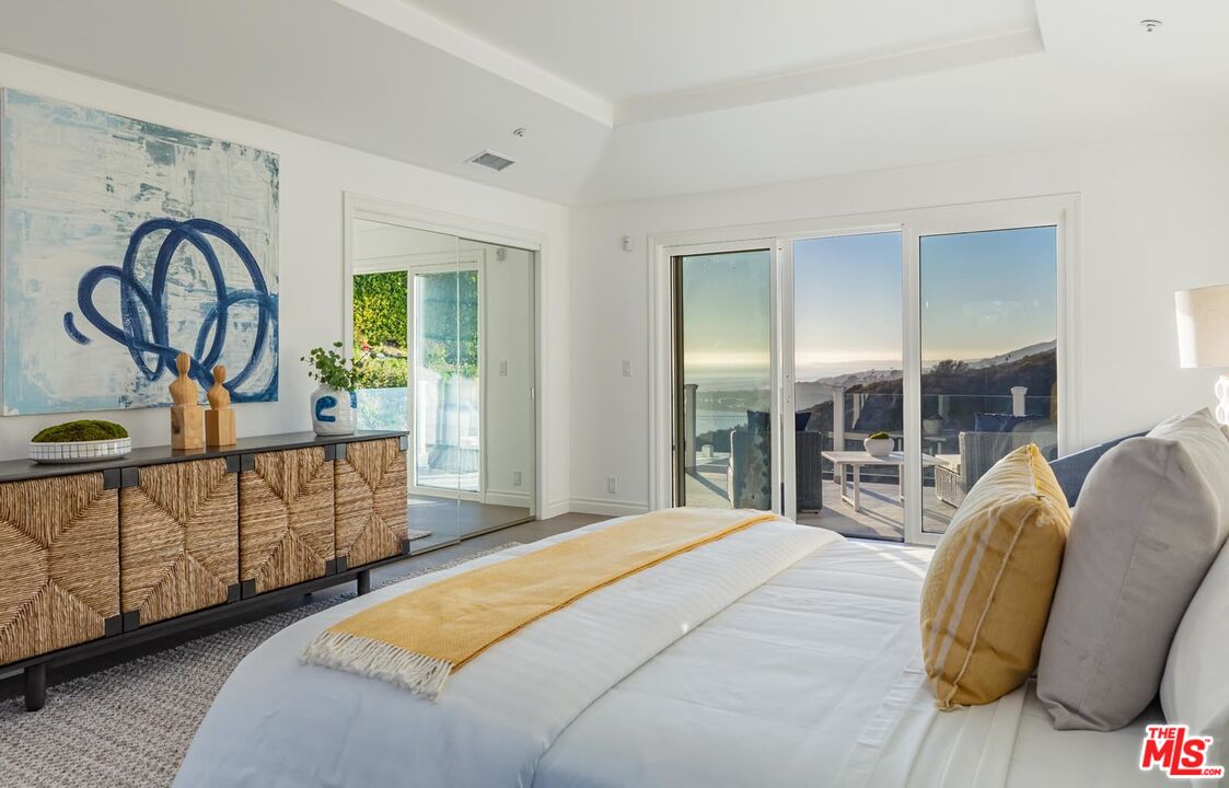 Carbon Mesa Road Malibu, CA 90265 - Photo 24 of 42 a bedroom with furniture and a window