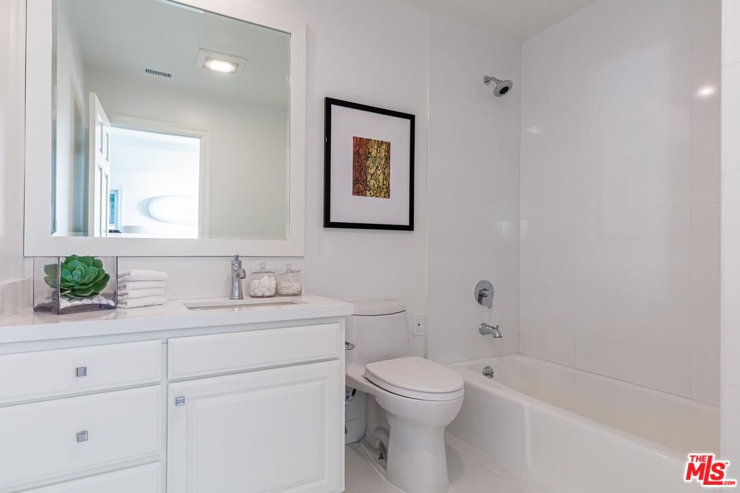 Carbon Mesa Road Malibu, CA 90265 - Photo 25 of 42 a bathroom with a toilet a sink a tub and a mirror