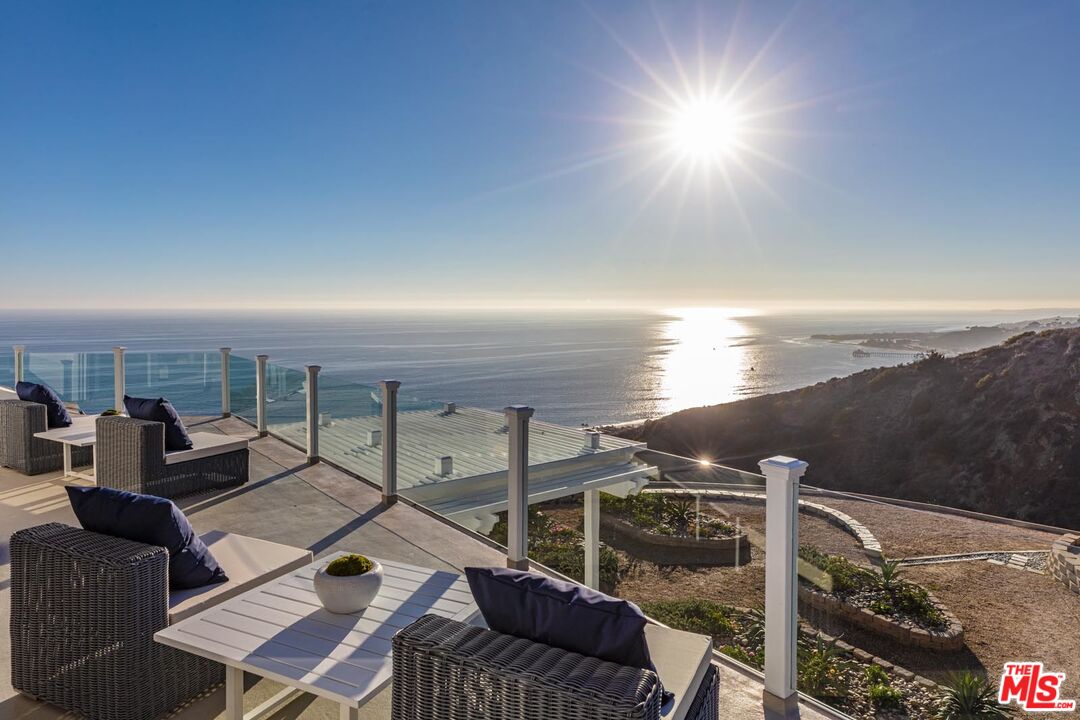 Carbon Mesa Road Malibu, CA 90265 - Photo 26 of 42 a terrace with outdoor seating and city view