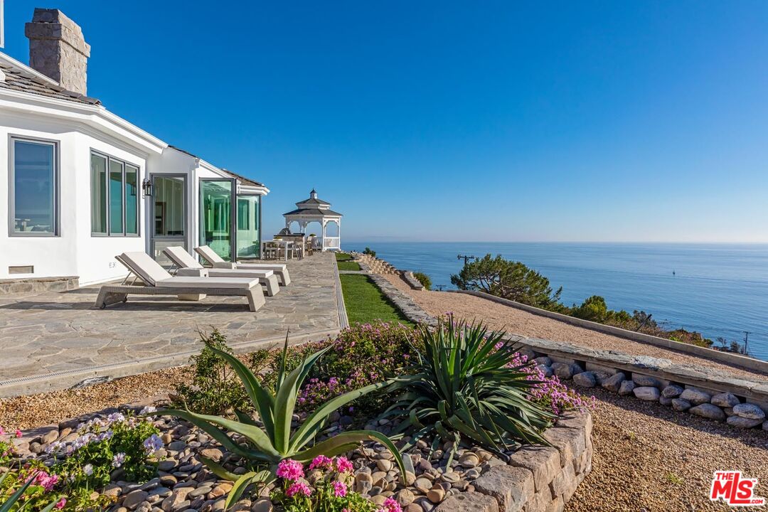Carbon Mesa Road Malibu, CA 90265 - Photo 39 of 42 a view of a chairs and table in the patio with a swimming pool