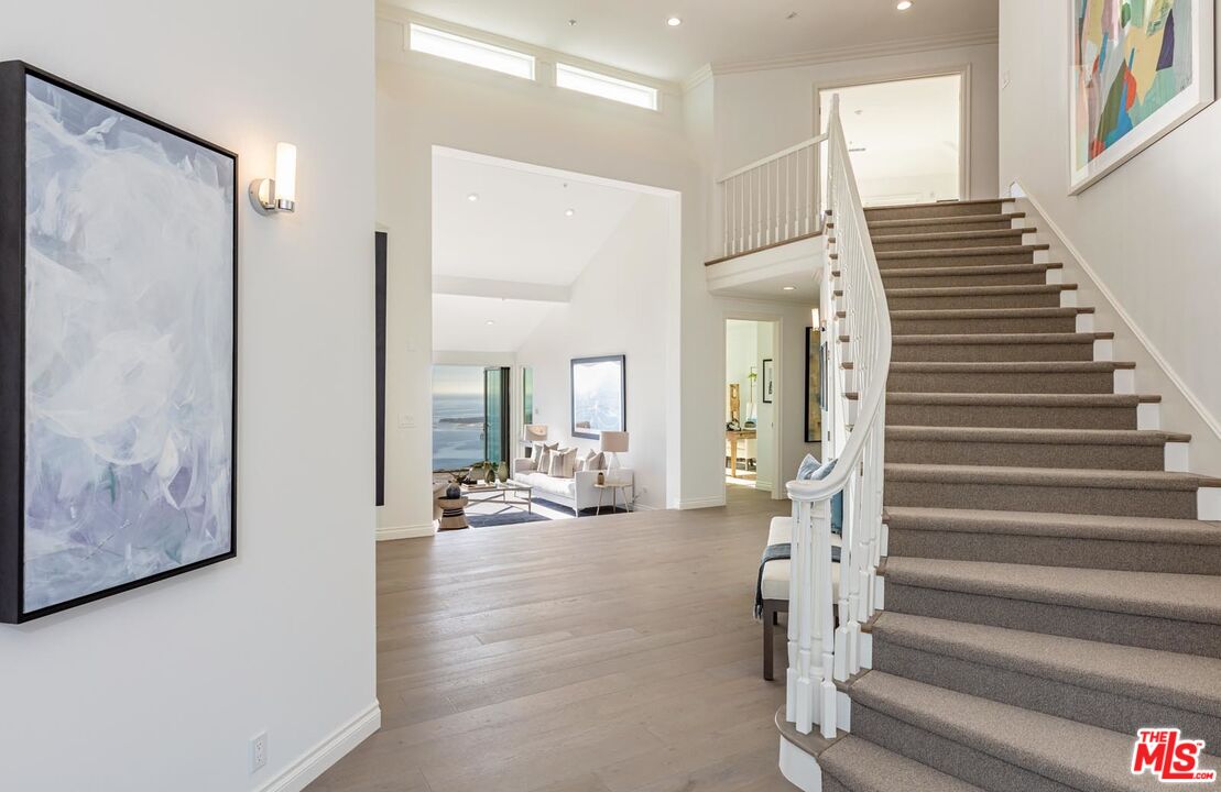 Carbon Mesa Road Malibu, CA 90265 - Photo 4 of 42 a view of a hallway with wooden floor and workspace