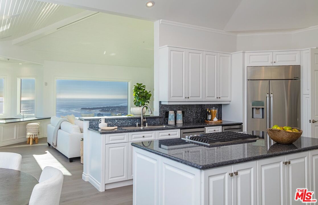 Carbon Mesa Road Malibu, CA 90265 - Photo 7 of 42 a kitchen with white cabinets and appliances
