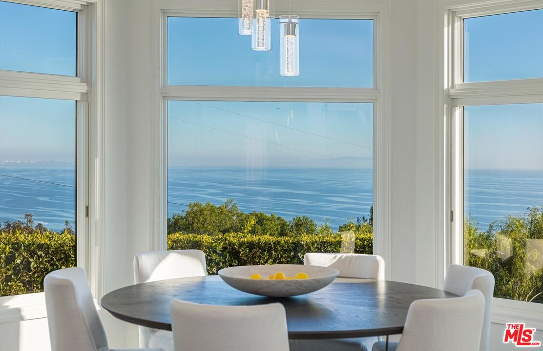 Carbon Mesa Road Malibu, CA 90265 - Photo 8 of 42 a view of a dining room with furniture and a potted plant
