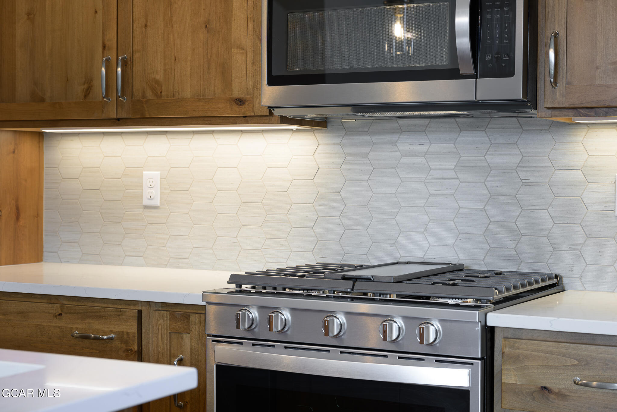 96 Meadow Trail, Unit G101 Fraser, CO 80442 - Photo 13 of 19 a stove top oven sitting inside of a kitchen
