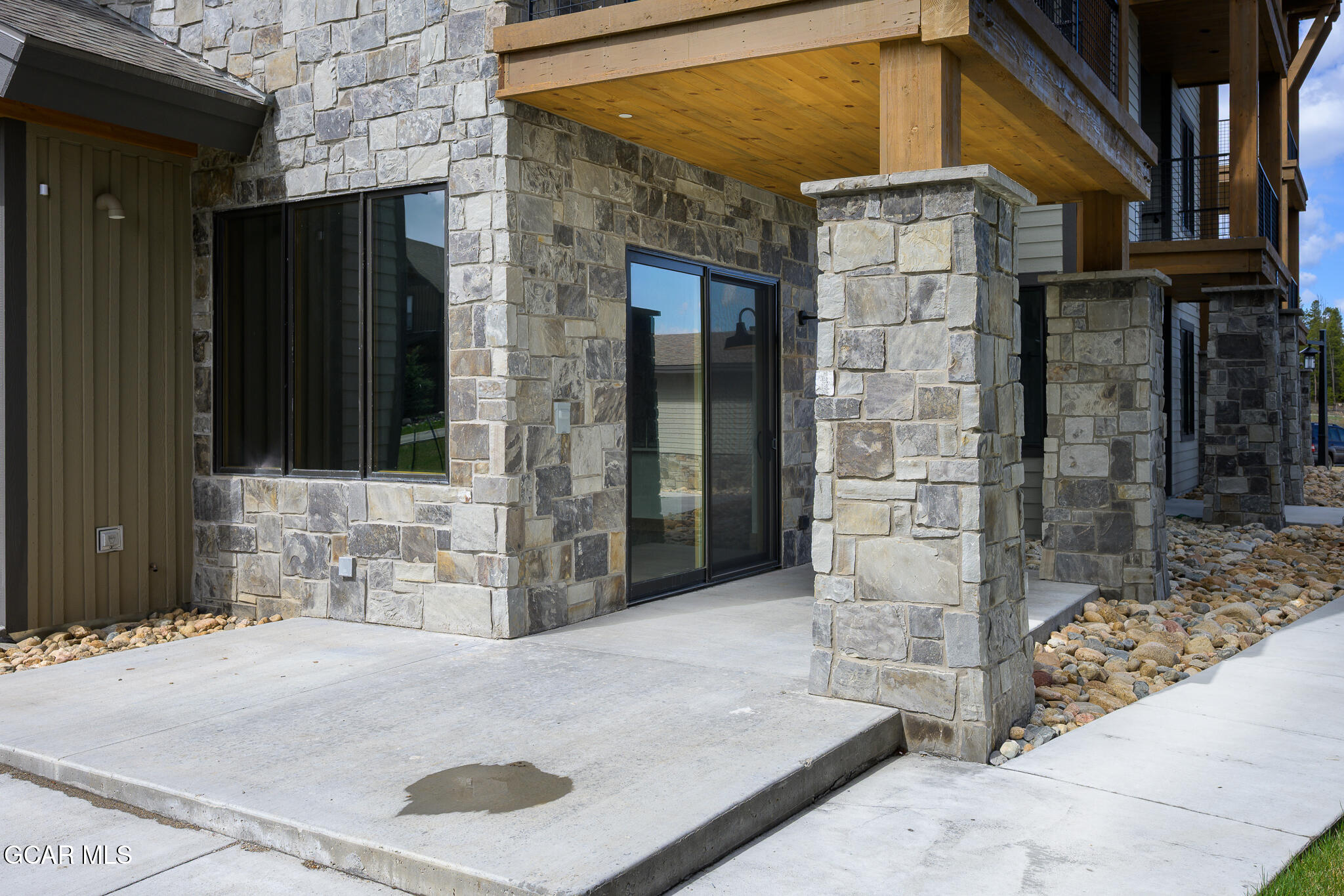 96 Meadow Trail, Unit G101 Fraser, CO 80442 - Photo 17 of 19 a brick building with a black door and a window