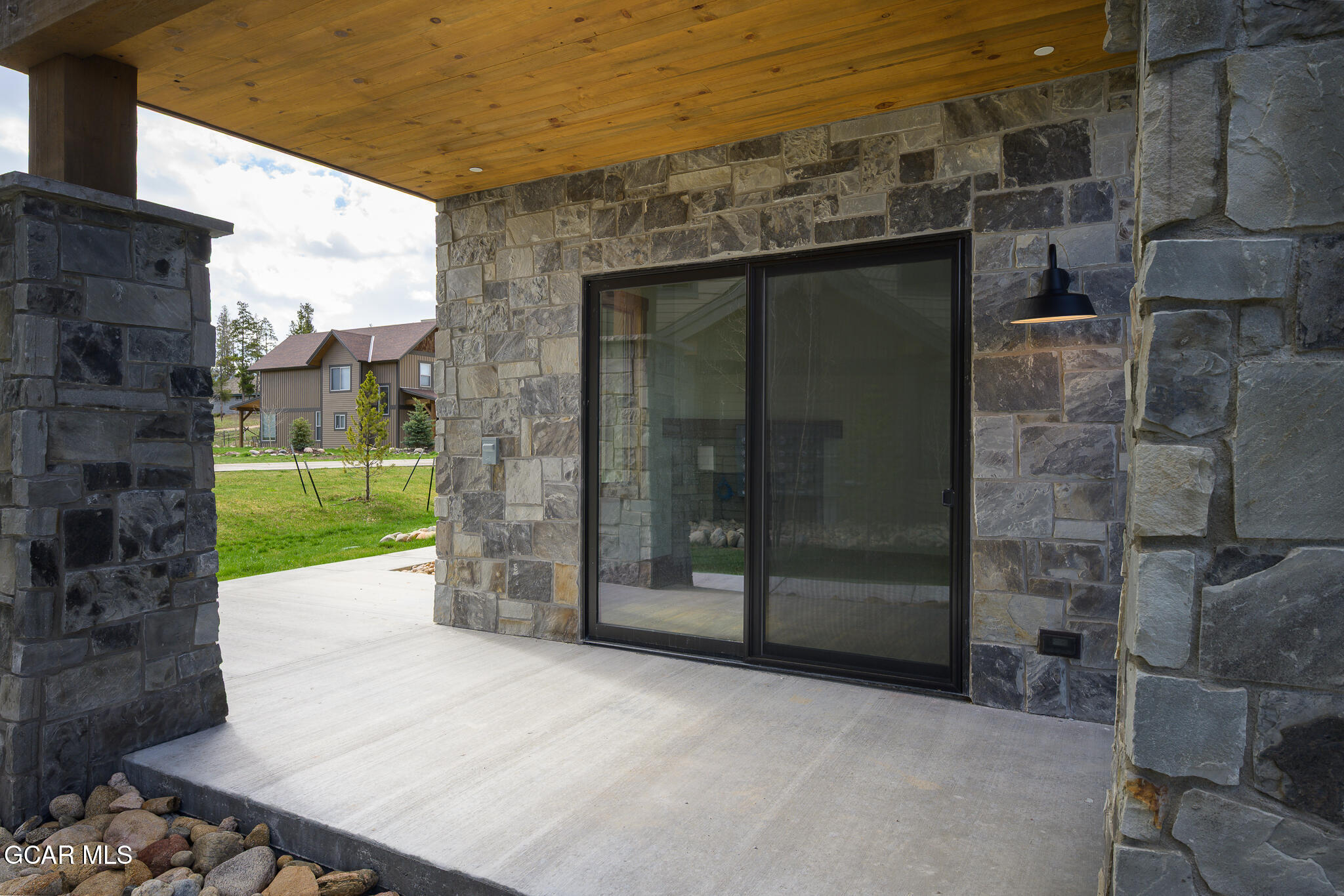 96 Meadow Trail, Unit G101 Fraser, CO 80442 - Photo 18 of 19 a view of a brick house with a large door