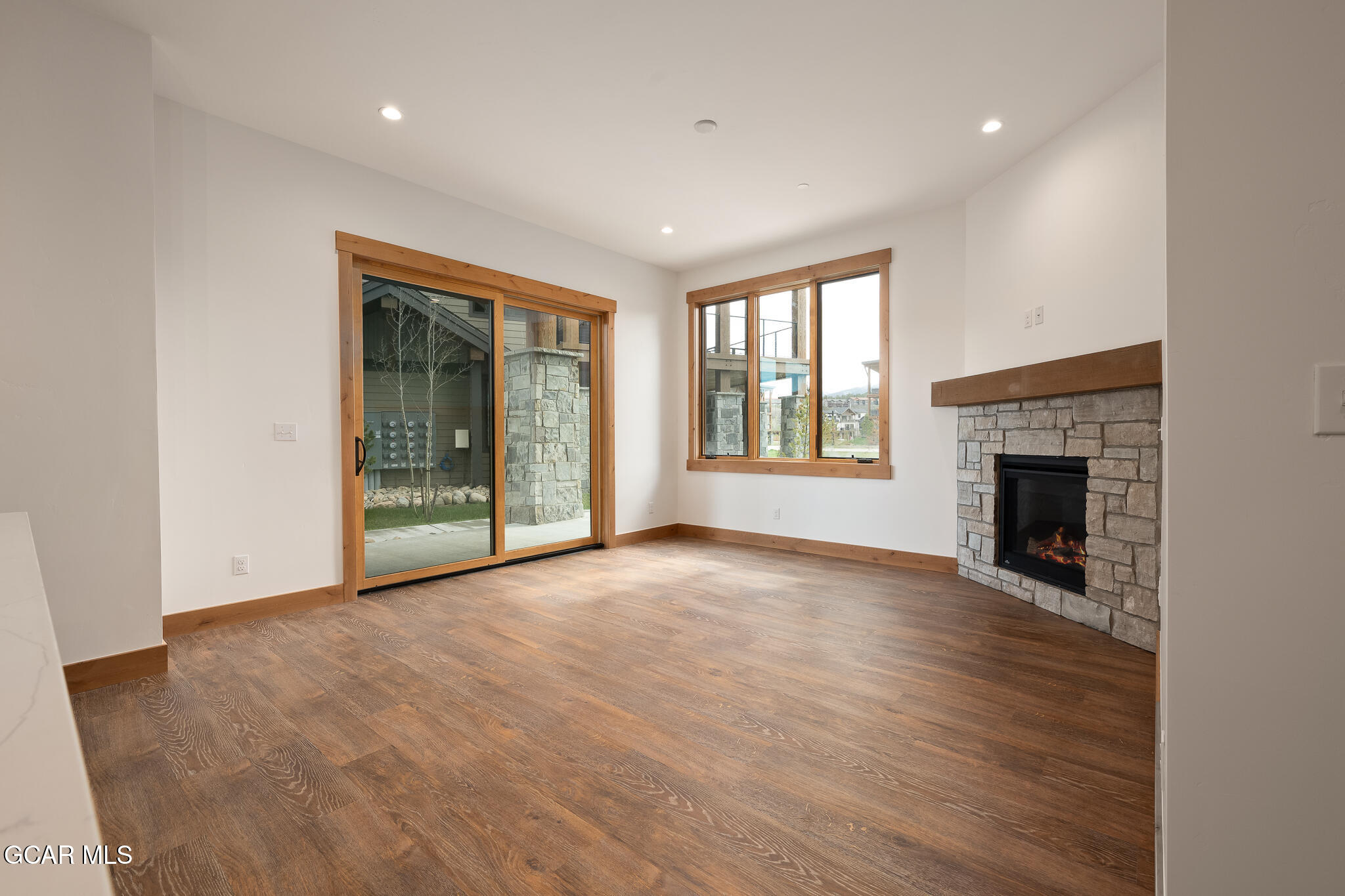 96 Meadow Trail, Unit G101 Fraser, CO 80442 - Photo 2 of 19 a view of an empty room with a window and fireplace